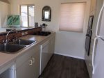 Side of kitchen with sink, DW, range top